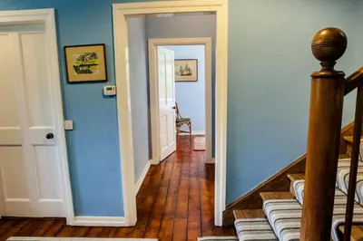 a hallway with blue walls and a wooden floor at Shelburne Lodge in Cairnbaan
