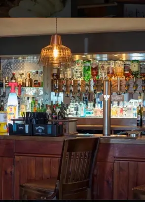 a bar in a restaurant with a bar counter at Harbourlights Accomodation in Irvine