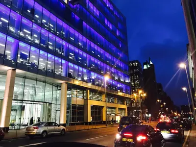 a building with purple lights on the side of a street at Glasgow Central Station SKYLINE Apartment with Parking (2 bedrooms, 2 bathrooms, 1 living room-Kitchen) in Glasgow