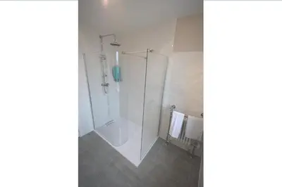 a shower with a glass door in a bathroom at Lettermay House in Lochgoilhead