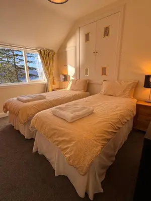 two beds sitting next to each other in a bedroom at The Sheiling in Saint Fillans