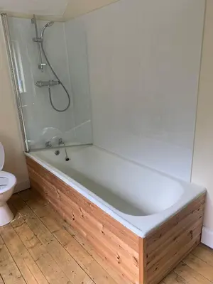 a bathroom with a bath tub and a toilet at The Sheiling in Saint Fillans