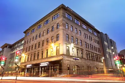 a building on the corner of a street with traffic lights at Hotel Indigo Glasgow by IHG in Glasgow