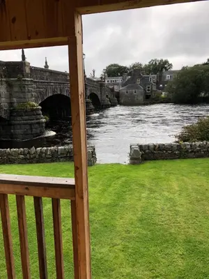a view of a river from a porch at The Toll House in Newton Stewart