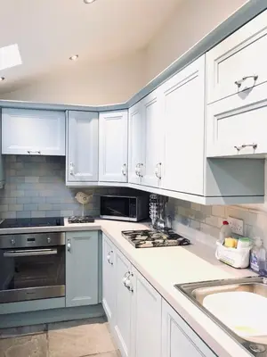 a kitchen with white cabinets and a sink at The Toll House in Newton Stewart