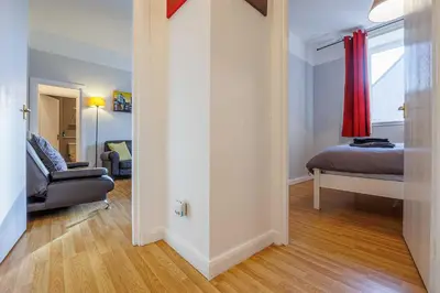 a living room with a bed and a couch at Linlithgow Apartment in Linlithgow