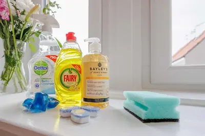 a counter with two bottles of cleaning products and a sponge at Linlithgow Apartment in Linlithgow