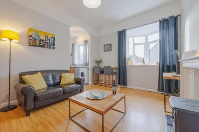 a living room with a couch and a table at Linlithgow Apartment in Linlithgow