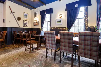 a dining room with a table and chairs at Village Inn in Arrochar
