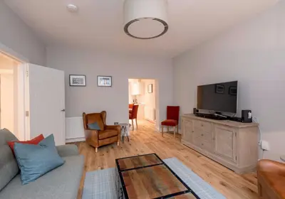 a living room with a couch and a flat screen tv at Luxury apartment, Stafford Street in Edinburgh