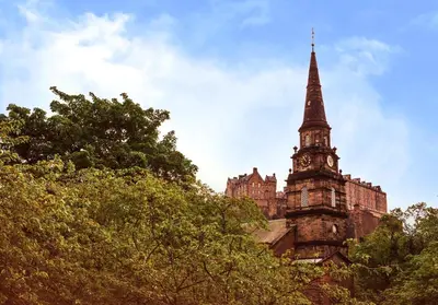 an old building with a tower with a clock on it at Luxury apartment, Stafford Street in Edinburgh