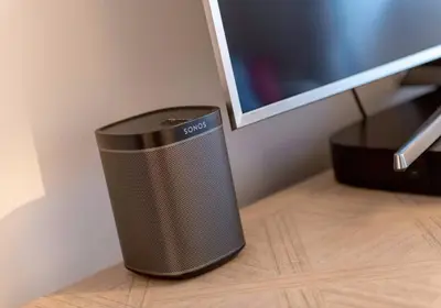 a speaker sitting on a desk next to a computer monitor at Luxury apartment, Stafford Street in Edinburgh