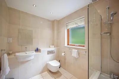 a bathroom with a toilet and a sink and a shower at Seabank Lodge in Oban