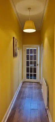 an empty room with yellow walls and a window at Millhill St Dunfermline in Dunfermline