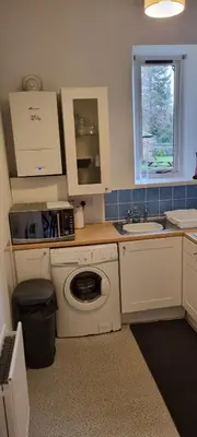 a kitchen with a washing machine and a sink at Millhill St Dunfermline in Dunfermline