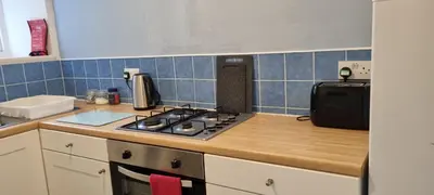 a kitchen with a stove and a counter top at Millhill St Dunfermline in Dunfermline
