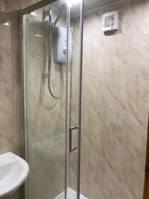 a shower with a glass door in a bathroom at The Greannan Lower Self catering apartment in Blackwaterfoot