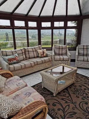 a living room with a couch and chairs and a table at The Greannan Lower Self catering apartment in Blackwaterfoot