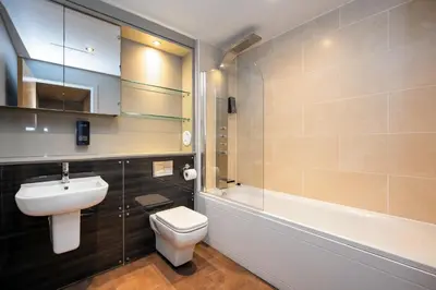a bathroom with a toilet and a sink and a shower at Staycity Aparthotels Edinburgh West End in Edinburgh