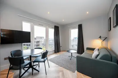 a living room with a couch and a table at Staycity Aparthotels Edinburgh West End in Edinburgh