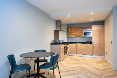 a kitchen and dining room with a table and chairs at Staycity Aparthotels Edinburgh West End in Edinburgh