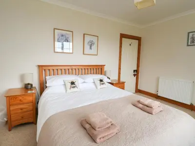a bedroom with a bed with two towels on it at Drover's Way in Newyork
