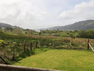a fence in a field with mountains in the background at Drover's Way in Newyork