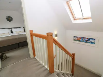 a stairway leading to a bedroom with a skylight at Muirmailing Cottage in Plean