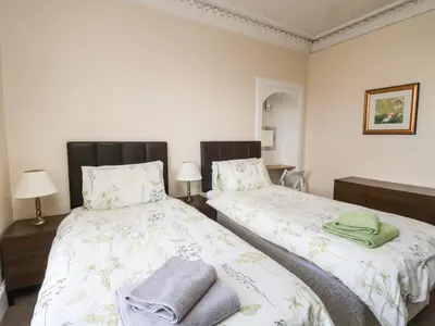 a bedroom with two beds with towels on them at The Knowe Lower in Taynuilt