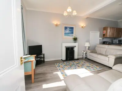 a living room with a couch and a fireplace at The Knowe Lower in Taynuilt