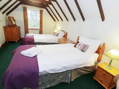 a bedroom with two beds and a window at Tulchan Lodge in Buchanty