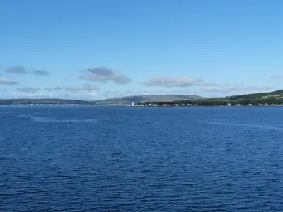 a large body of water with mountains in the background at Woodstock Lodge in Skelmorlie