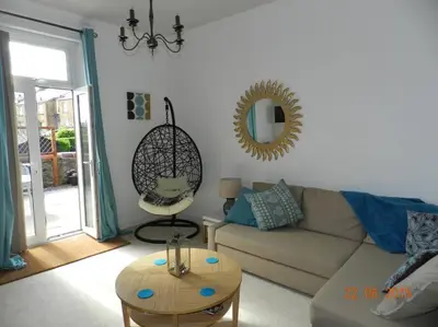 a living room with a couch and a table at Troon Beachcombers in Troon