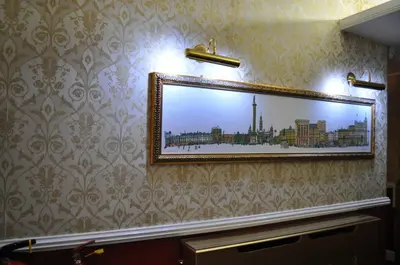 a mirror on a wall with a picture of a city at Argyll Guest House in Glasgow