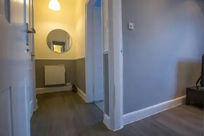 a room with a hallway with a mirror and a door at Stylish City Apartment - Near Haymarket, Walk to Castle and Princes Street in Edinburgh