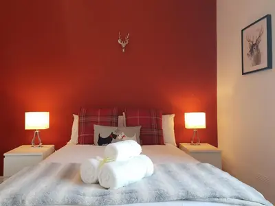 a bedroom with a bed with towels on it at Stylish City Apartment - Near Haymarket, Walk to Castle and Princes Street in Edinburgh