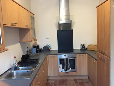 a kitchen with a sink and a stove top oven at Scotstoun 1 Bed Flat in Glasgow