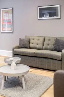 a living room with a couch and a coffee table at JOIVY Luxurious Home near Haymarket Station in Edinburgh