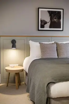 a bedroom with two beds and a small table at JOIVY Luxurious Home near Haymarket Station in Edinburgh