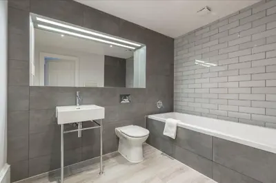 a bathroom with a sink and a toilet and a bath tub at JOIVY Luxurious Home near Haymarket Station in Edinburgh