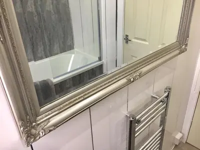 a mirror on the wall of a bathroom at RIVER CLYDE VIEWS - PRIVATE & SPACIOUS APARTMENT in Port Glasgow