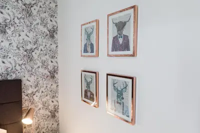 a row of framed pictures on a wall at The Torfin in Edinburgh