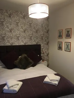 a bedroom with a bed with two towels on it at The Torfin in Edinburgh