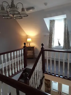 a staircase in a house with a window at Craigbank Guest House in Crianlarich
