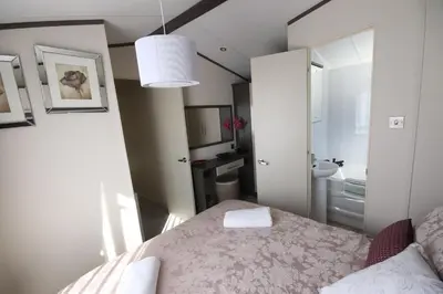 a bedroom with a bed and a bathroom with a sink at Jackson Lodge in Perth