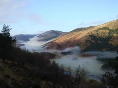 a misty valley in the mountains with a view at The Fortingall in Kenmore