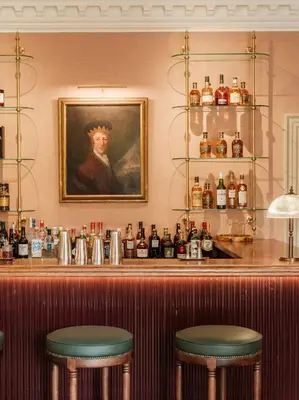 a bar with two stools and a painting of a woman at The Fortingall in Kenmore