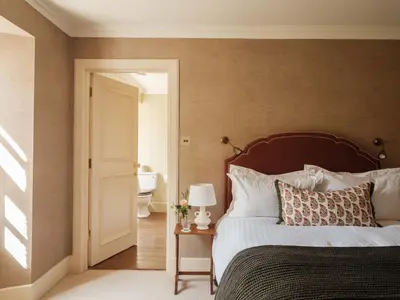 a bedroom with a bed and a bathroom at The Fortingall in Kenmore