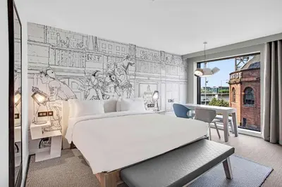 a bedroom with a bed and a drawing on the wall at Radisson RED Hotel, Glasgow in Glasgow