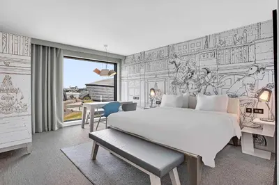 a bedroom with a large white bed and a desk at Radisson RED Hotel, Glasgow in Glasgow
